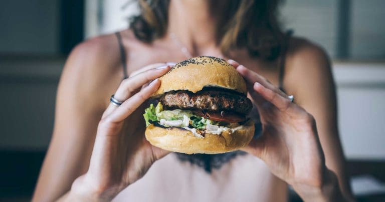 person holding foodprint hamburger