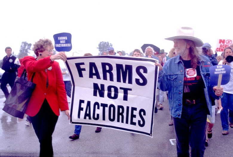 willie nelson carrying farms not factories sign 2019 farm crisis