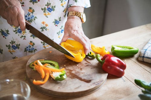 person chopping sweet peppers