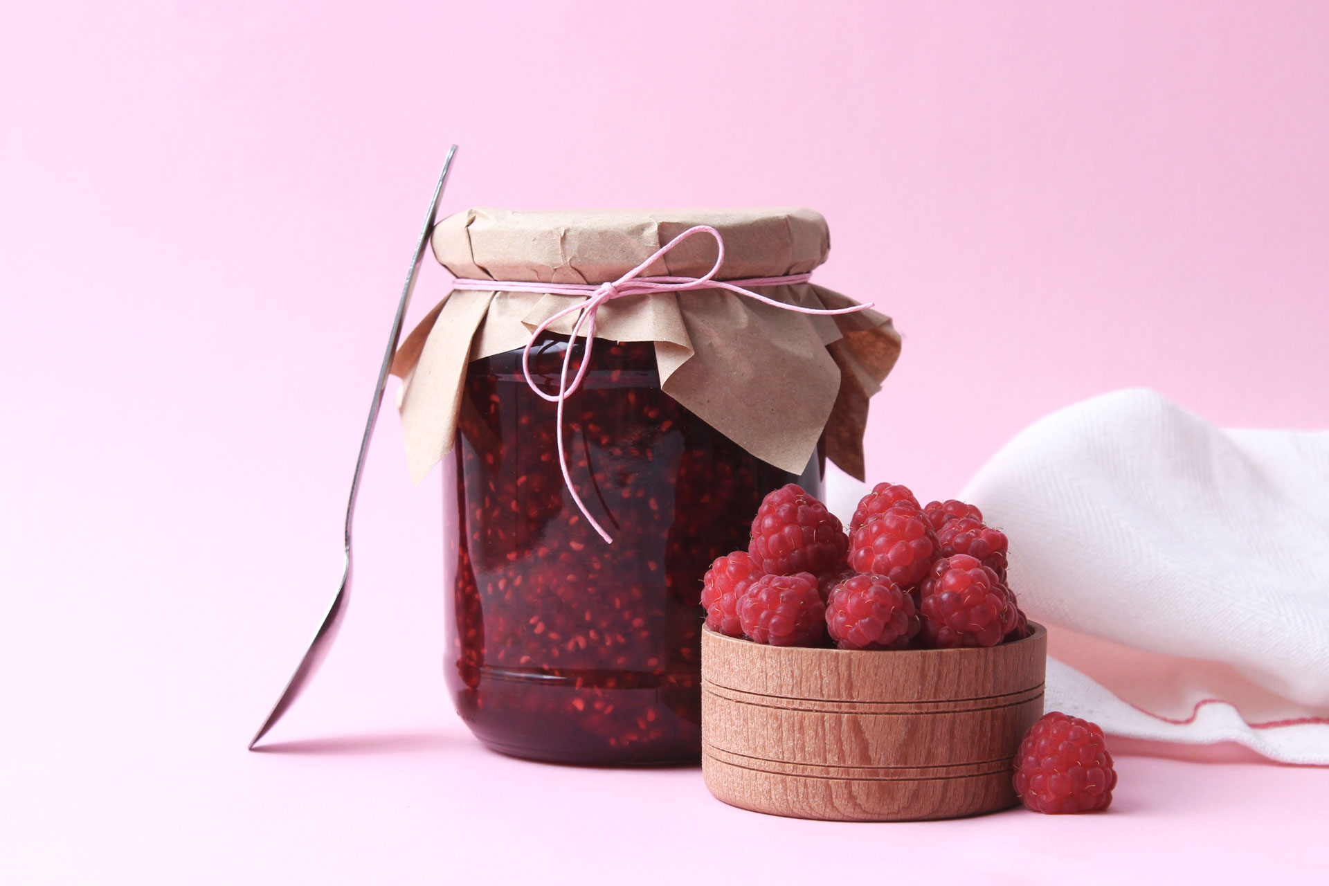 homemade jam from raspberries on a colored background