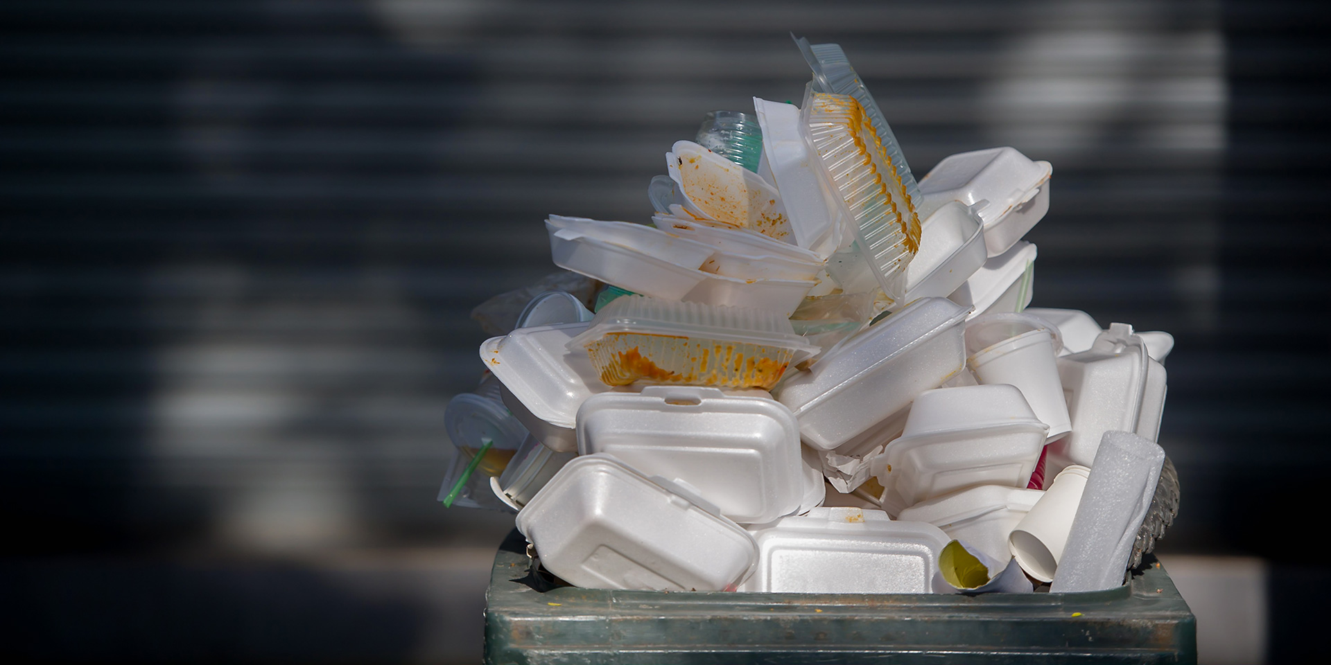 styrofoam and plastic food containers piled up