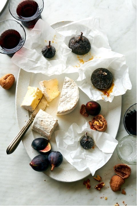 Candied figs on a plate with honey and cheese