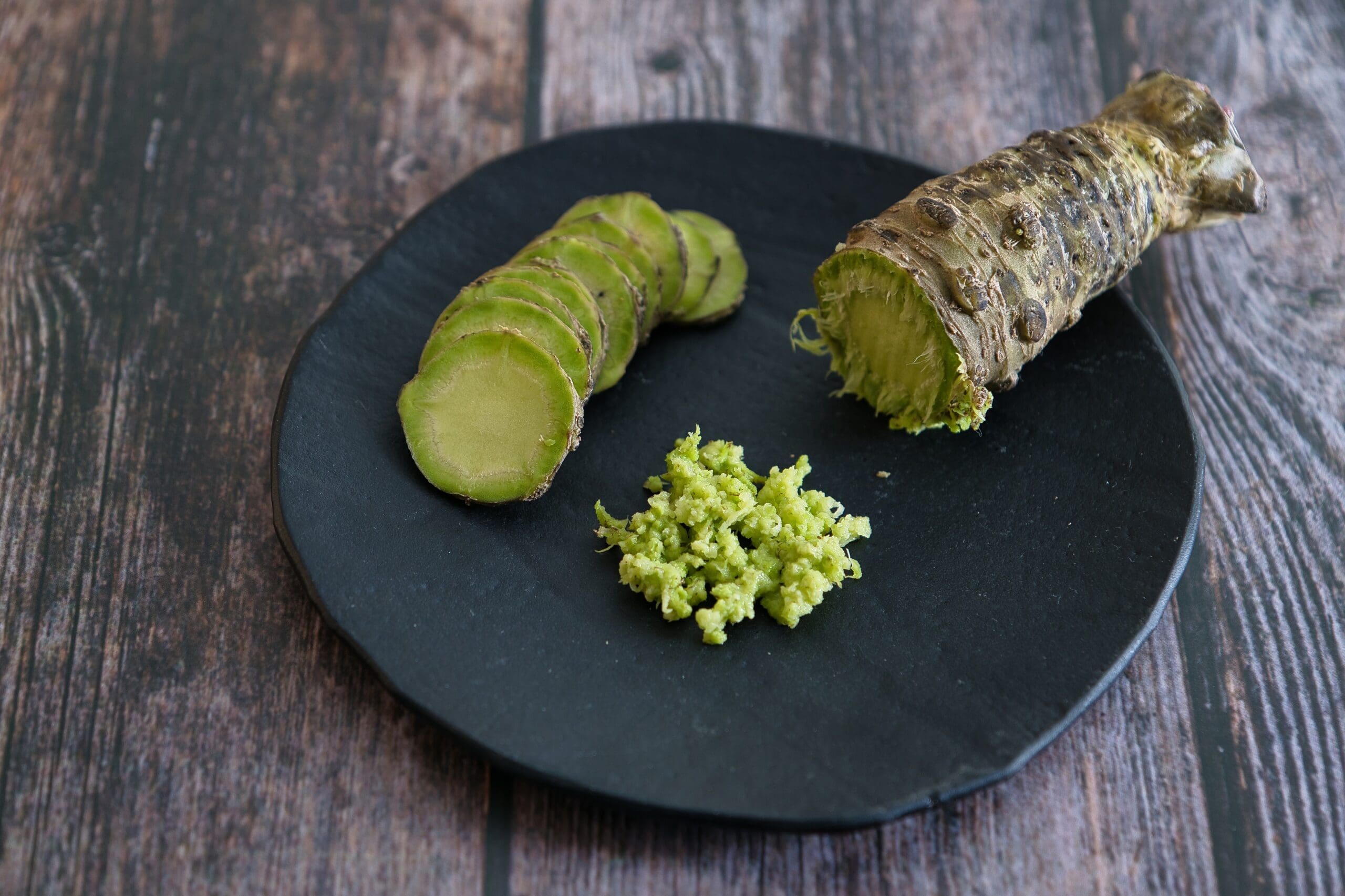 a plate with sliced and grated wasabi or Japanese horseradish