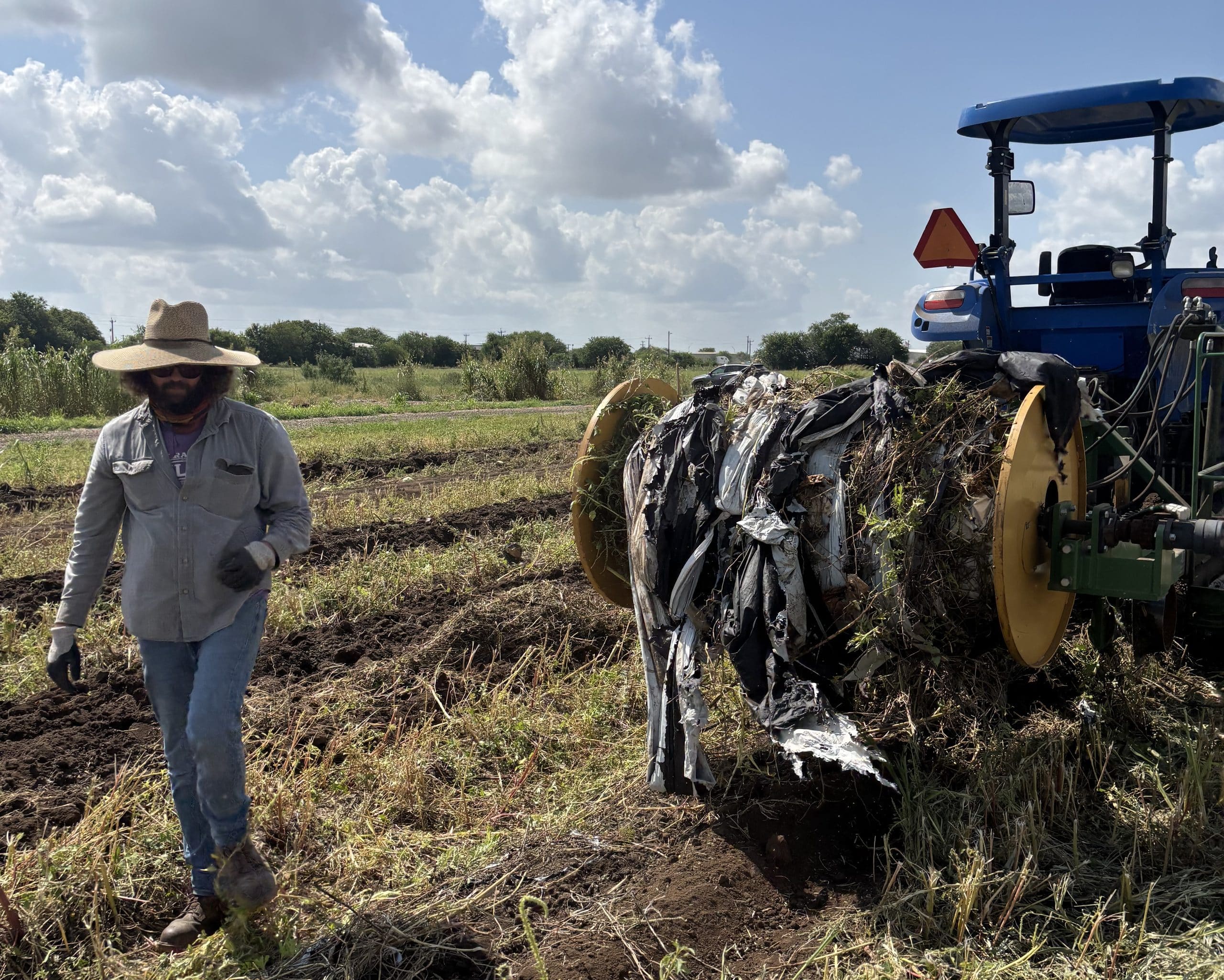 plastic mulch film being removed and tangled in a tractor