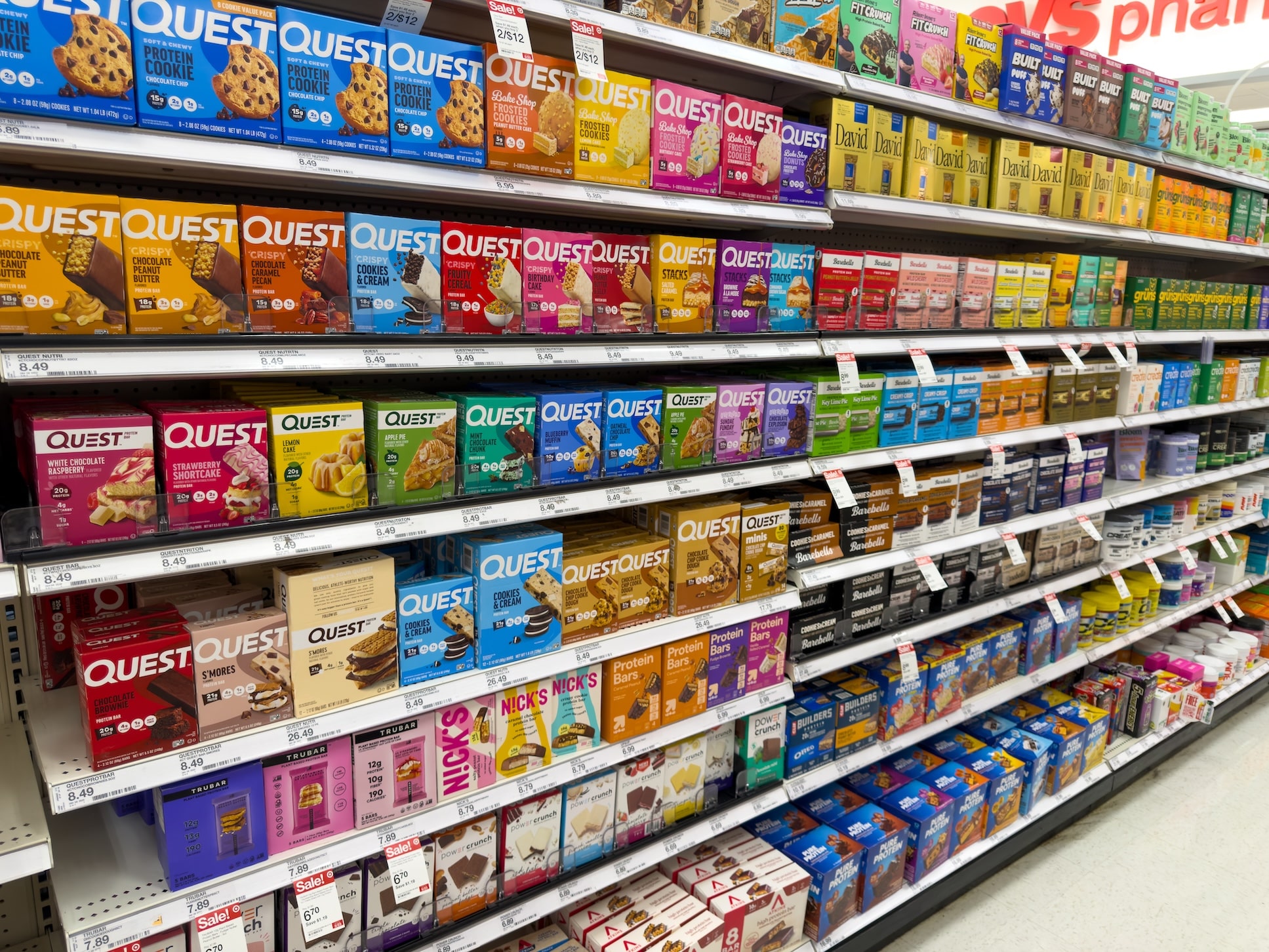 a row of nutrition bars and protein bars in a pharmacy